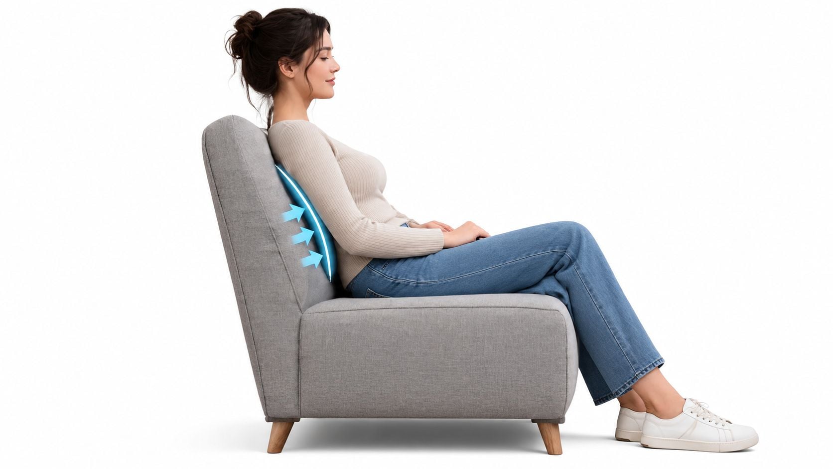 A woman sits comfortably in a gray upholstered armchair highlighting the chair's ergonomic tight back design.